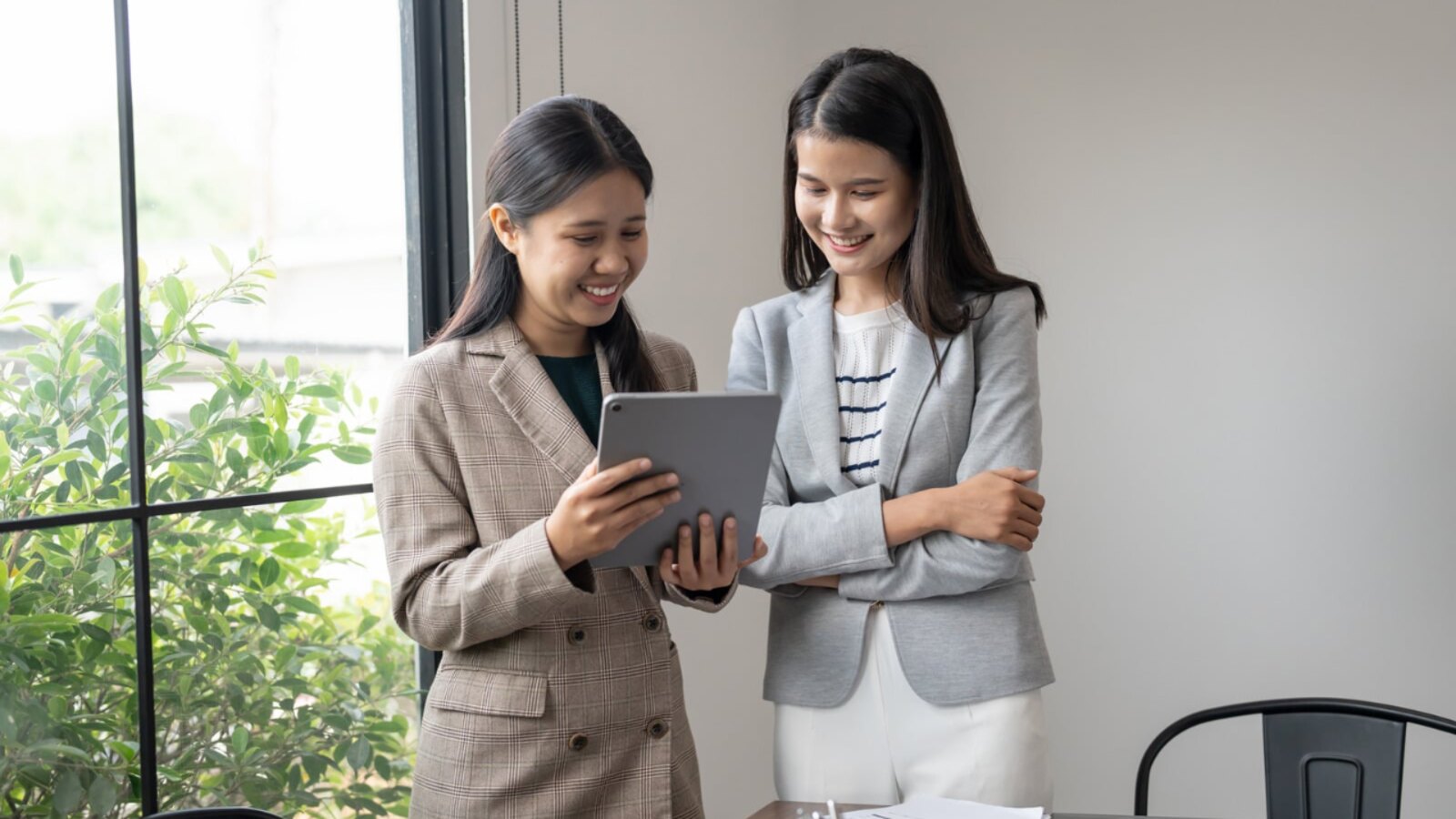 Cashflow smoothing: a small business owner planning month-to-month spend on a tablet